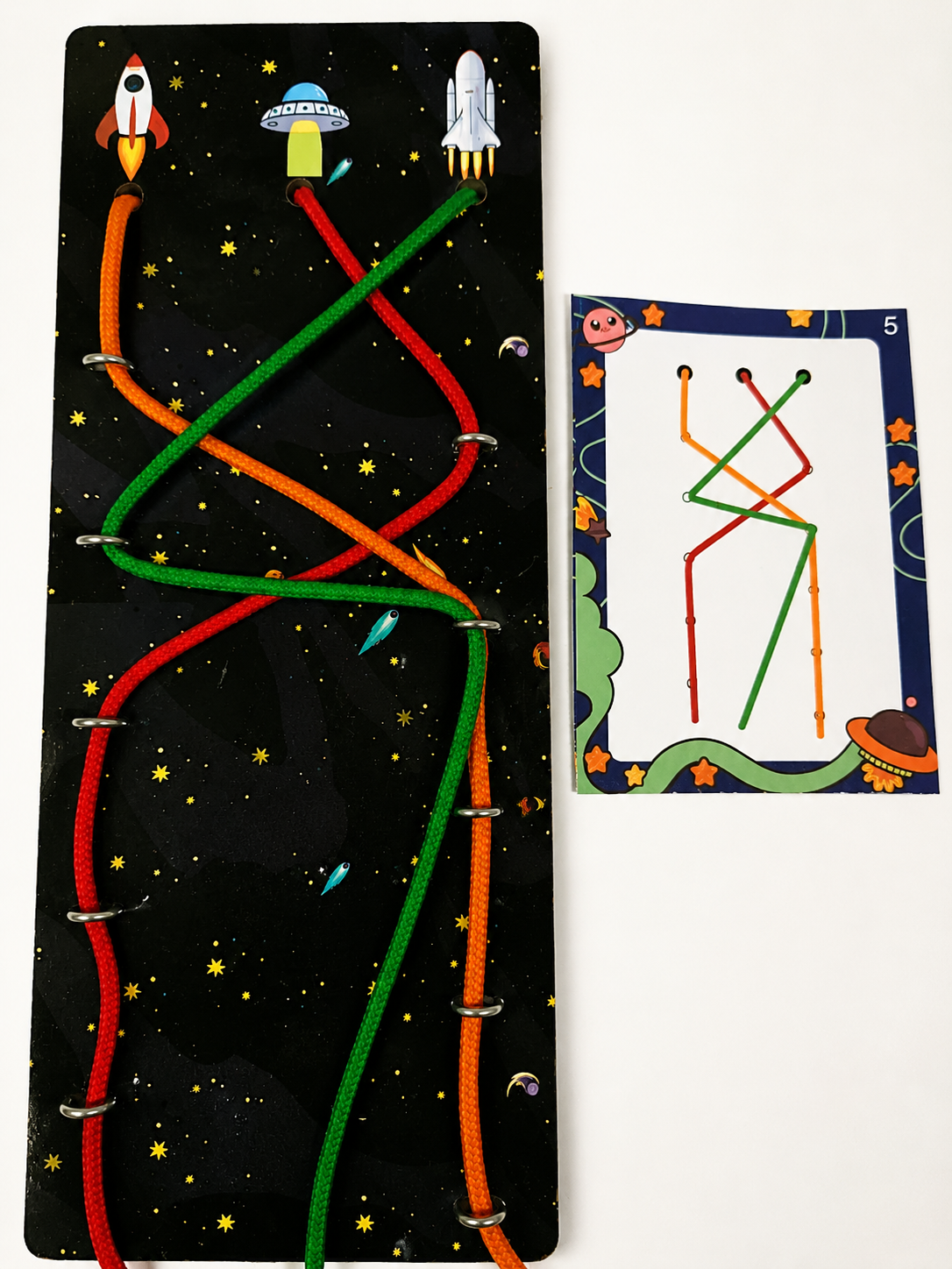 Children's educational toy with colorful paths on a space-themed board