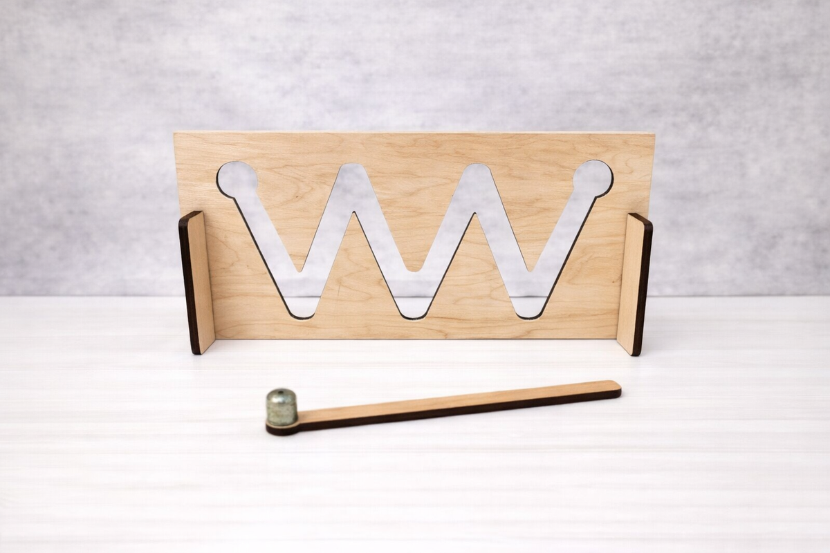 Wooden stand with metal 'W' letters on a white surface